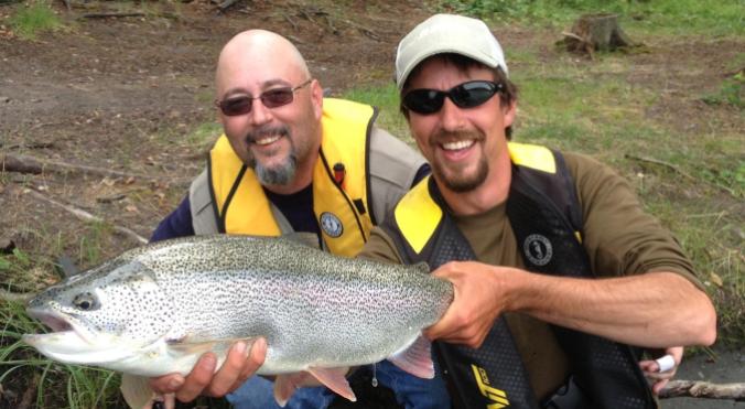 Phil and a client thrilled to with his catch of a big resident rainbow
